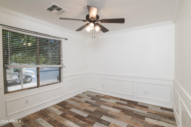 unfurnished room featuring dark hardwood / wood-style floors, ceiling fan, and crown molding