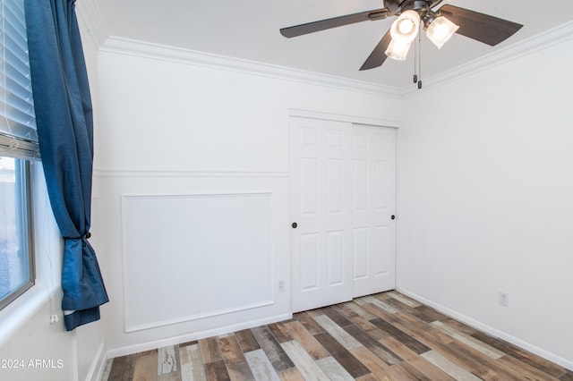 unfurnished bedroom featuring a closet, ceiling fan, hardwood / wood-style floors, and ornamental molding