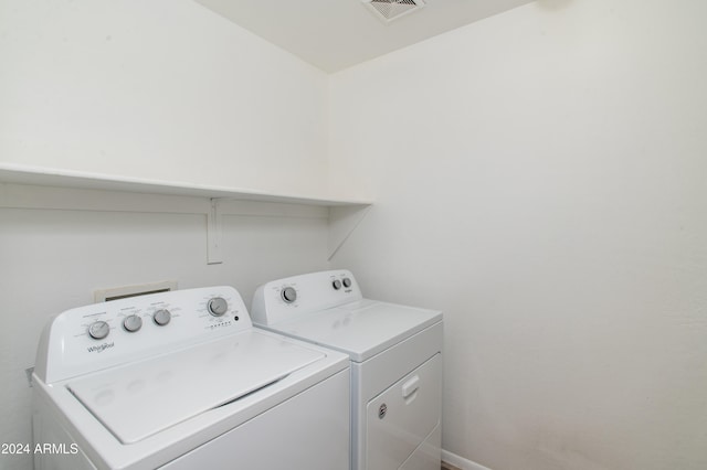 clothes washing area featuring washer and clothes dryer