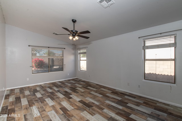 empty room featuring ceiling fan, dark wood-type flooring, and vaulted ceiling