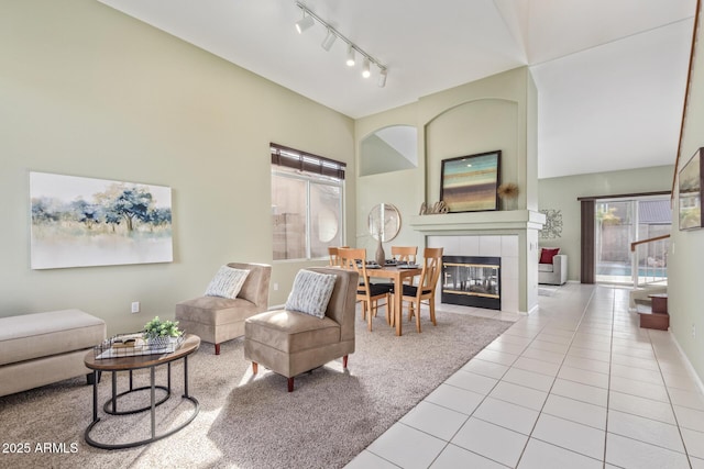 tiled living room featuring a fireplace and track lighting