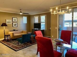 living room with crown molding, a healthy amount of sunlight, and ceiling fan with notable chandelier