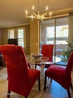 dining room with crown molding, a healthy amount of sunlight, and a notable chandelier