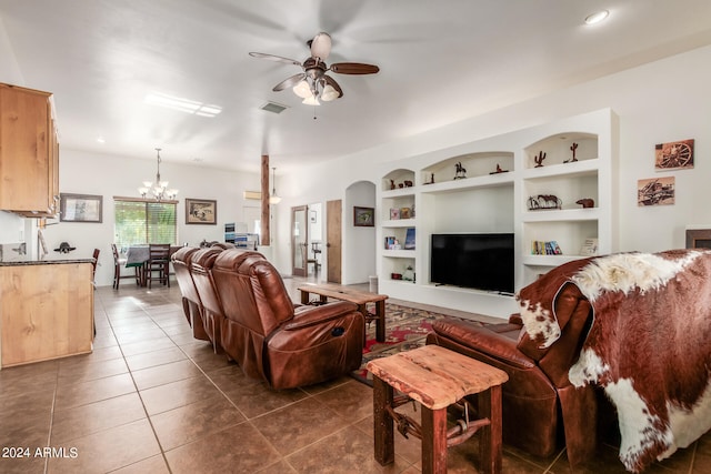 tiled living room featuring built in features and ceiling fan with notable chandelier