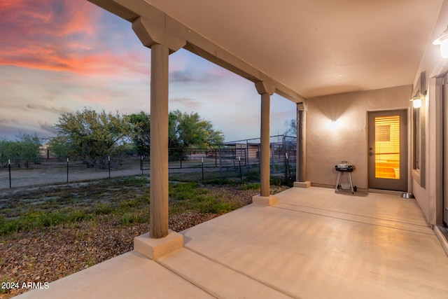 view of patio terrace at dusk