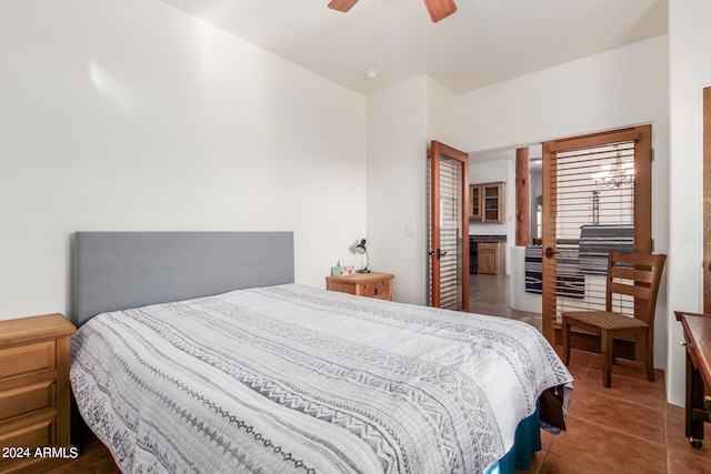 tiled bedroom featuring ceiling fan