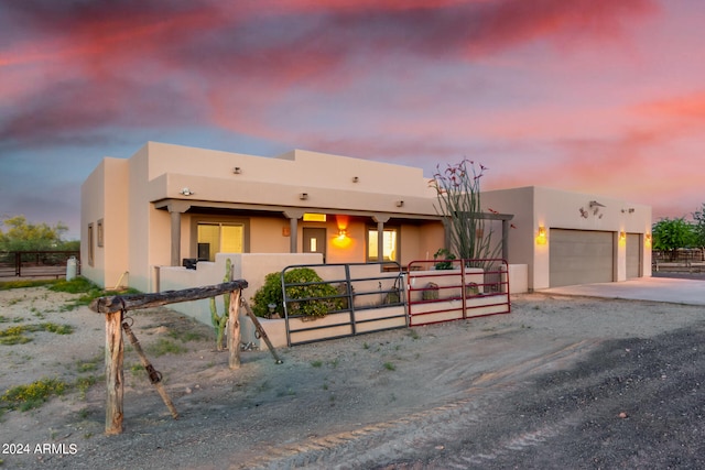 pueblo-style home with a garage