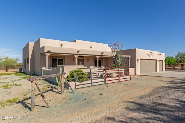 pueblo-style home with a garage