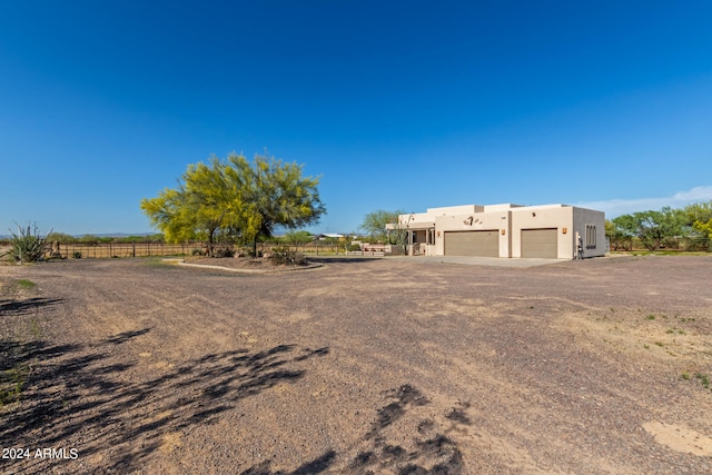 pueblo revival-style home with a garage