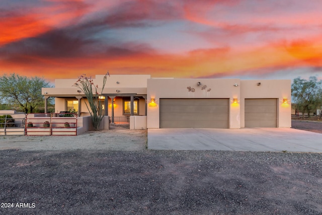 pueblo revival-style home with a garage