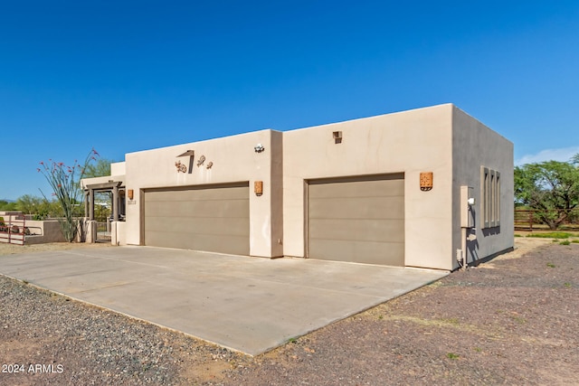 pueblo-style house with a garage