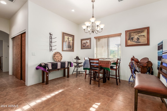 dining room with tile flooring and a notable chandelier