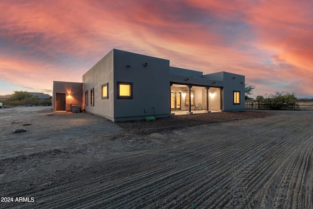 view of back house at dusk