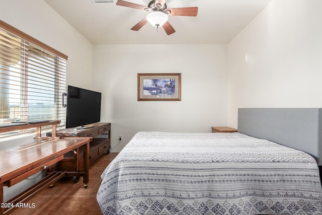 bedroom featuring dark tile flooring and ceiling fan