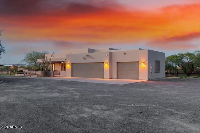 pueblo-style house with a garage