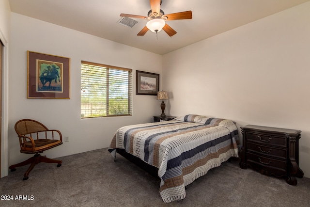 bedroom with ceiling fan and dark carpet