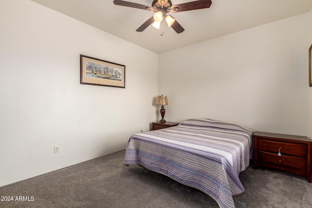 bedroom with ceiling fan and dark colored carpet