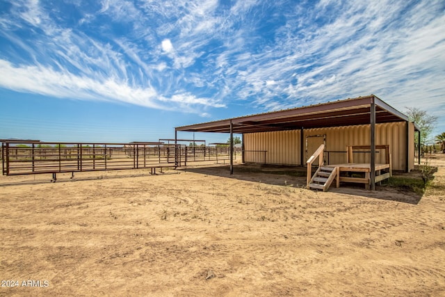 view of yard with a rural view and an outdoor structure