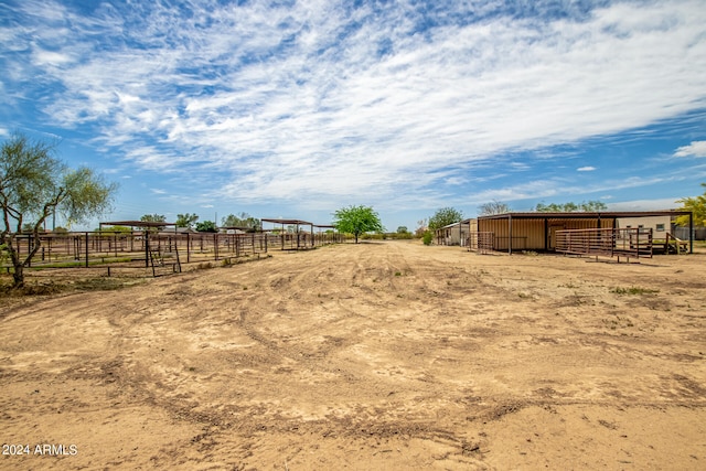 view of yard with a rural view and an outdoor structure