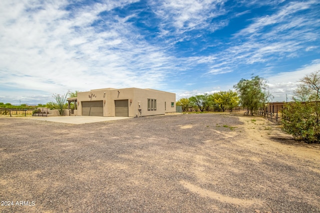 pueblo-style home with a garage