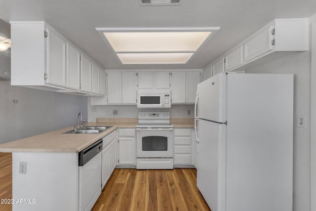 kitchen featuring white cabinets, white appliances, and sink