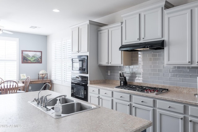 kitchen featuring ceiling fan, sink, black appliances, and tasteful backsplash