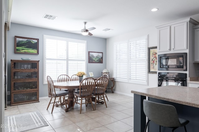 tiled dining room with ceiling fan