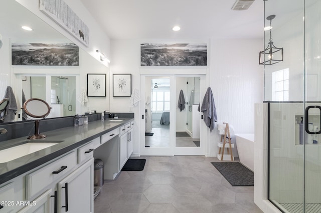 bathroom with shower with separate bathtub and vanity