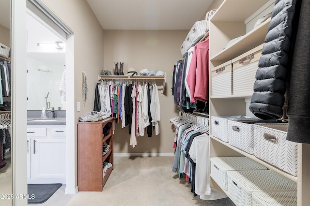 spacious closet with sink and light carpet