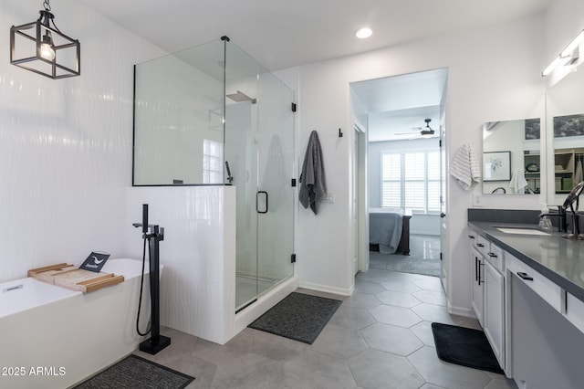 bathroom featuring ceiling fan, vanity, tile patterned floors, and shower with separate bathtub