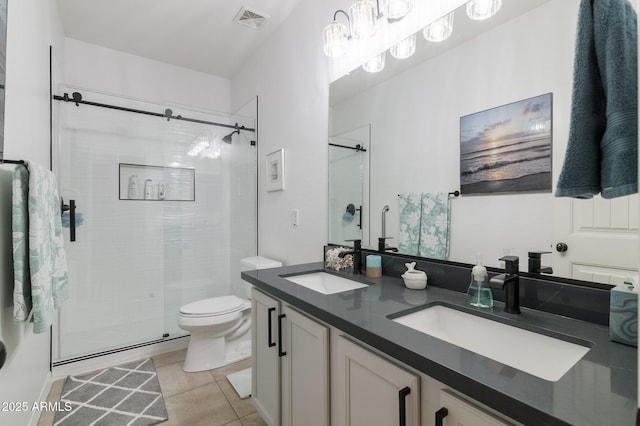 bathroom with a shower with door, tile patterned floors, vanity, and toilet