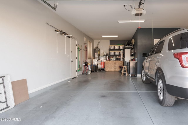 garage featuring water heater and a garage door opener