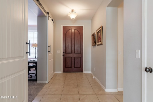 tiled entrance foyer with a barn door