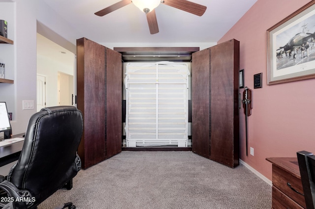 carpeted office space with ceiling fan