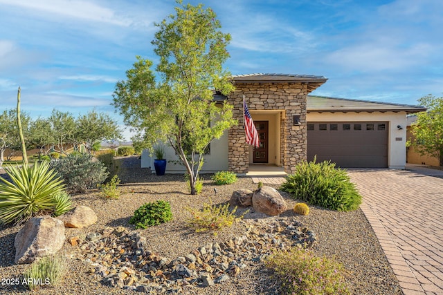 4246 Stage Stop Way, Wickenburg, AZ 85390 - view of front of property featuring a garage, decorative driveway, stone siding, and stucco siding