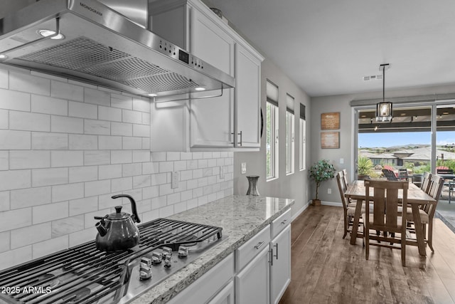 4246 Stage Stop Way, Wickenburg, AZ 85390 - kitchen featuring ventilation hood, baseboards, stainless steel gas stovetop, dark wood finished floors, and white cabinets