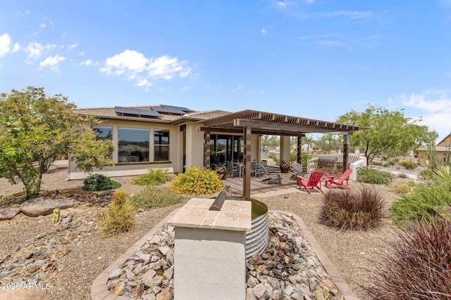 4246 Stage Stop Way, Wickenburg, AZ 85390 - back of house featuring solar panels, a patio area, and stucco siding