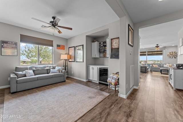 4246 Stage Stop Way, Wickenburg, AZ 85390 - living area with wine cooler, ceiling fan, wood finished floors, and plenty of natural light