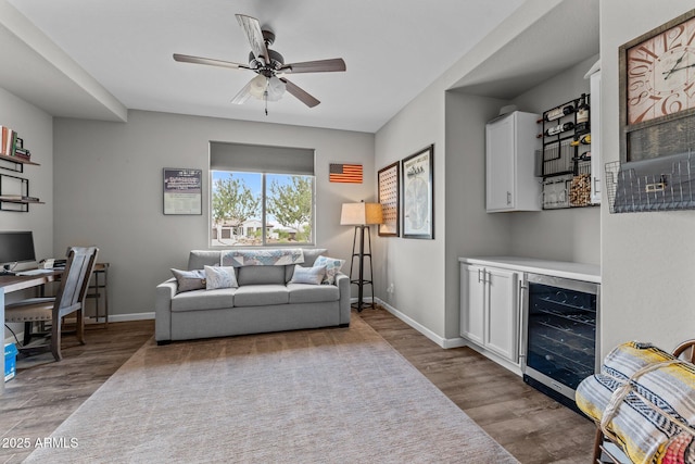 4246 Stage Stop Way, Wickenburg, AZ 85390 - living area with beverage cooler, wood finished floors, a ceiling fan, and a dry bar