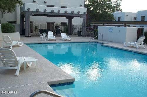 view of swimming pool with a pergola