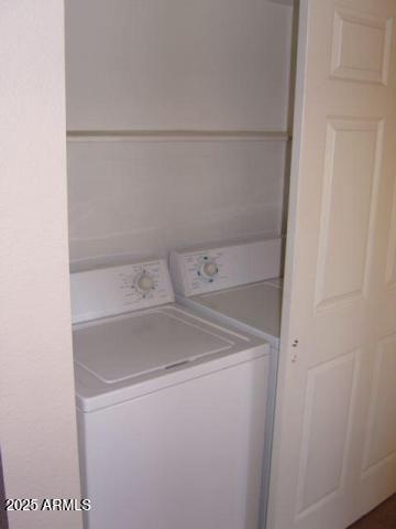 clothes washing area with washer and clothes dryer