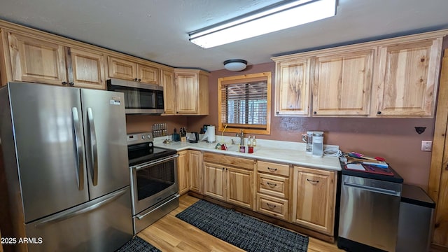 2425 Tall Trees Loop, Forest Lakes, AZ 85931 - kitchen featuring appliances with stainless steel finishes, light countertops, light brown cabinets, and light wood finished floors