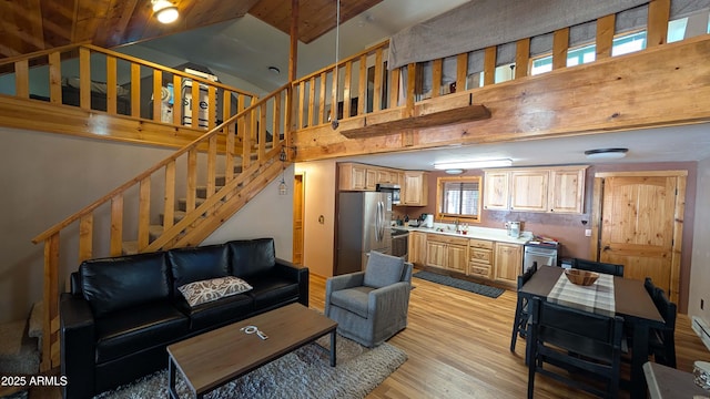 2425 Tall Trees Loop, Forest Lakes, AZ 85931 - living room with high vaulted ceiling, light wood-type flooring, and stairway