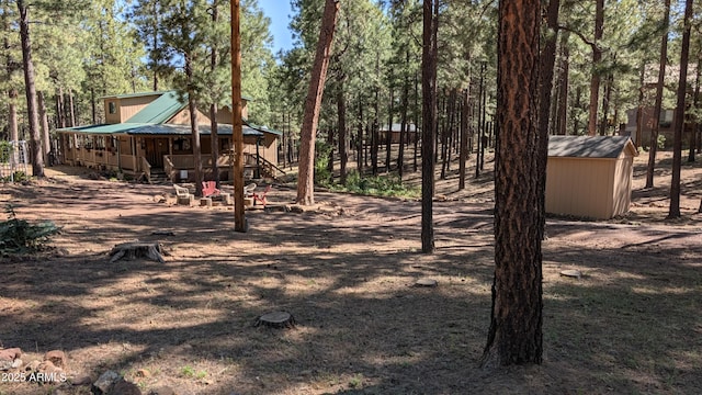 2425 Tall Trees Loop, Forest Lakes, AZ 85931 - view of yard with a storage shed, stairway, and a porch