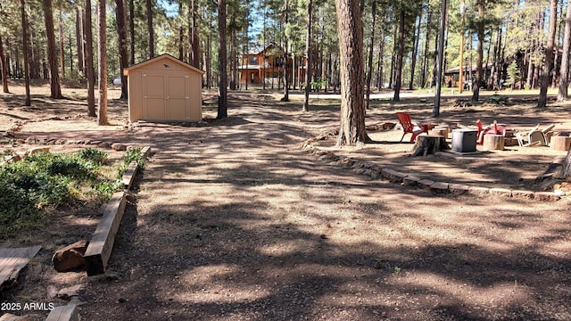 2425 Tall Trees Loop, Forest Lakes, AZ 85931 - surrounding community featuring a shed and view of wooded area
