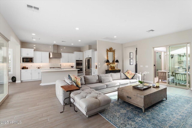 living room featuring light wood-type flooring and a wealth of natural light