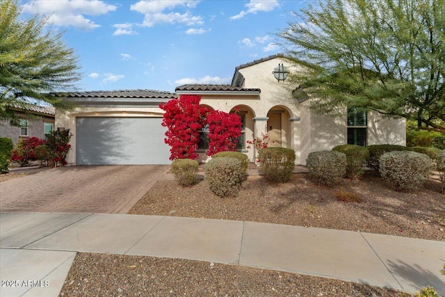 mediterranean / spanish-style house with a garage