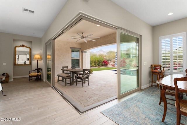 doorway to outside with ceiling fan and light hardwood / wood-style flooring