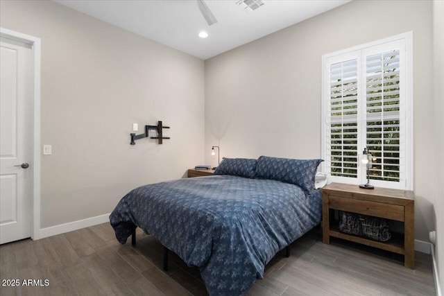 bedroom with ceiling fan and hardwood / wood-style flooring