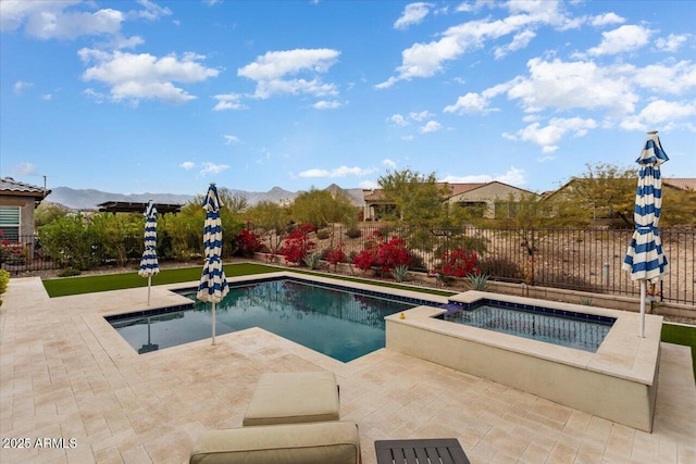 view of swimming pool featuring an in ground hot tub, a mountain view, and a patio